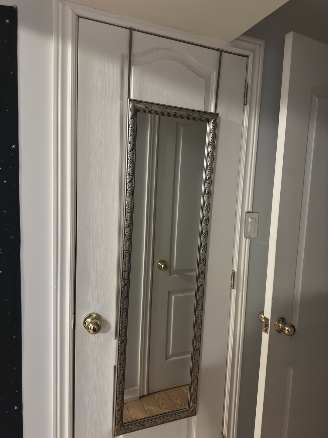 Over-the-door mirror with ornate frame