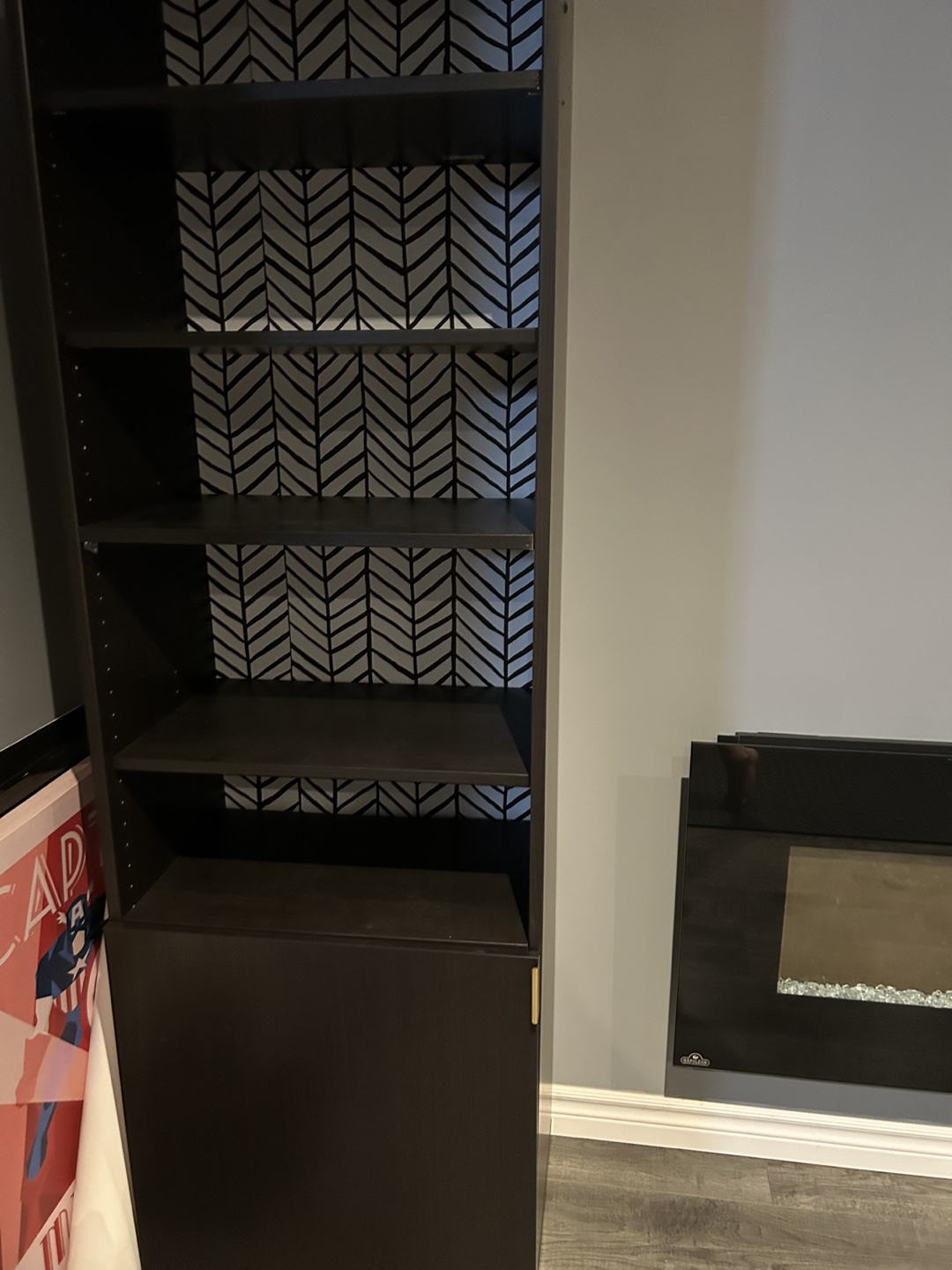 Tall dark brown bookshelf with herringbone patterned back
