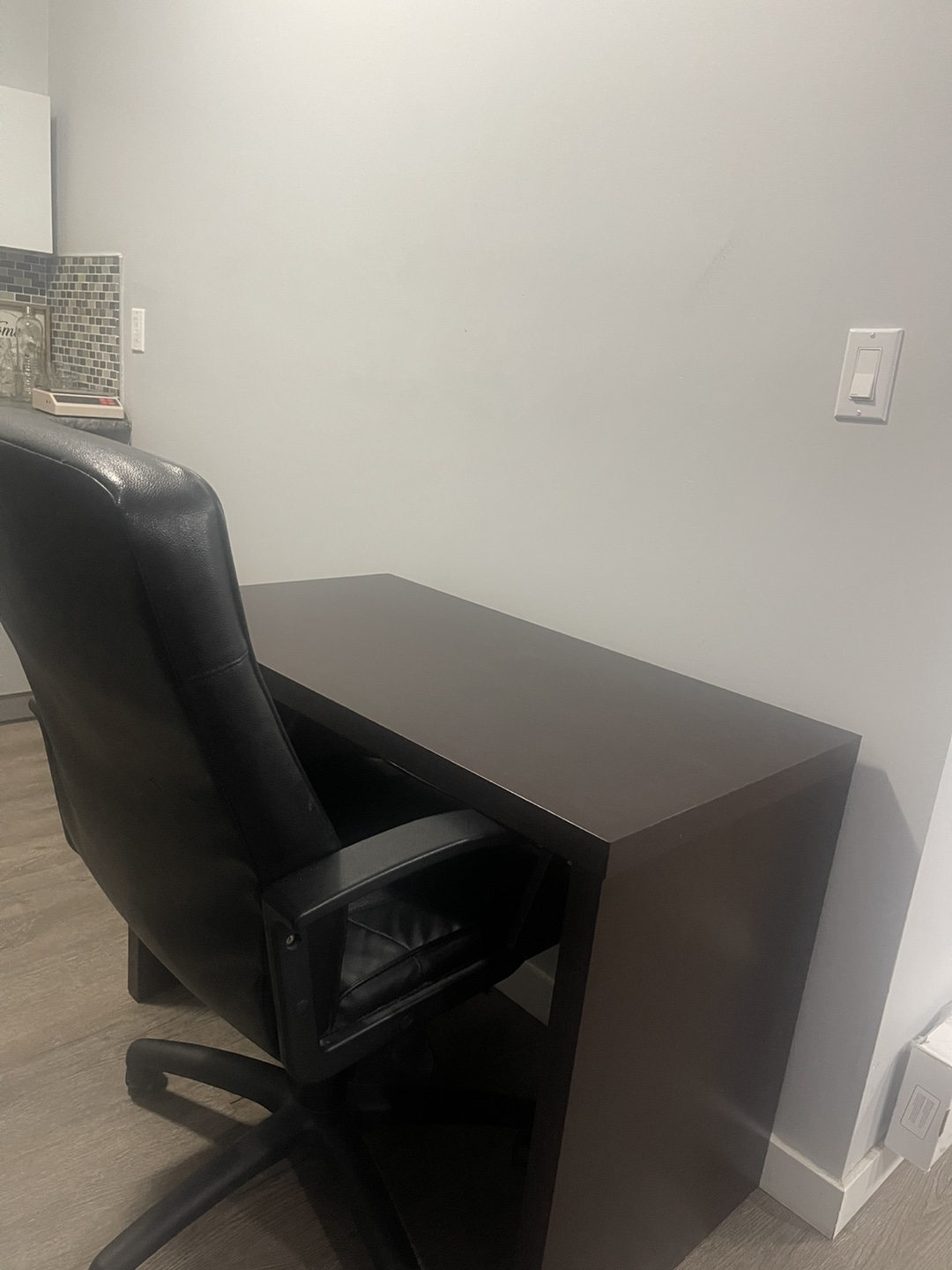 Dark brown computer desk with black office chair