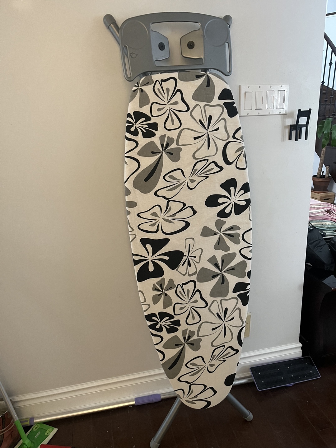 Wall-mounted ironing board with floral print