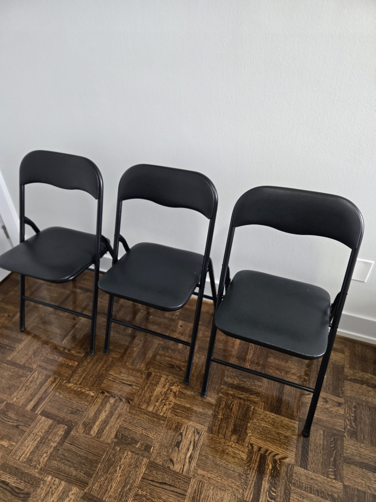 Three Black Folding Chairs