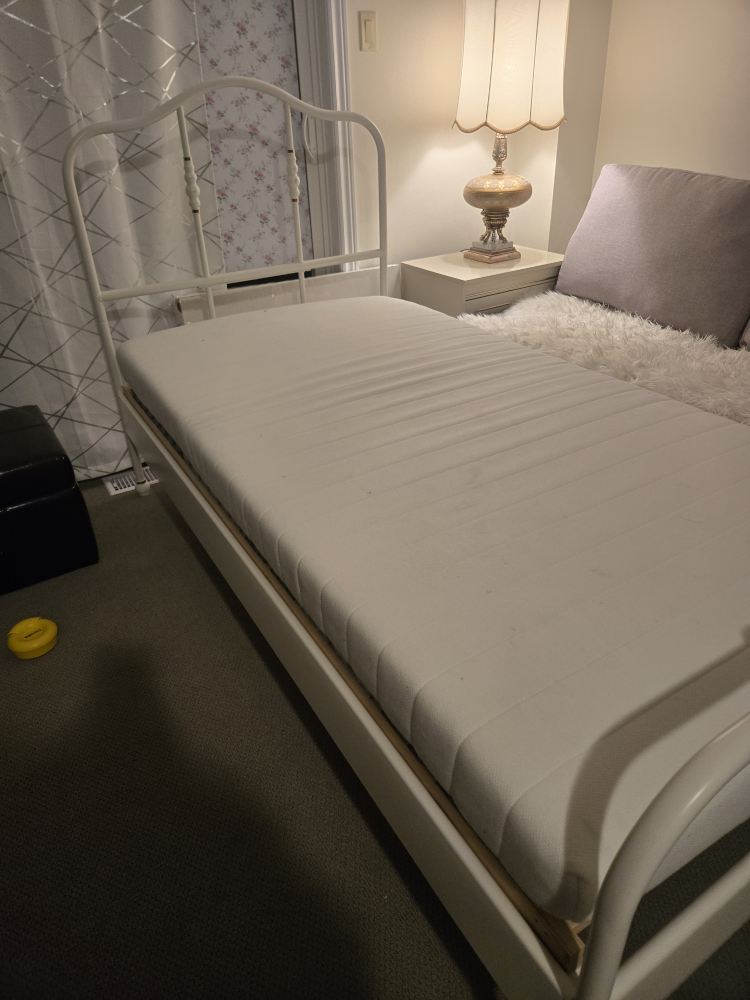 single white metal bed and mattress front IKEA