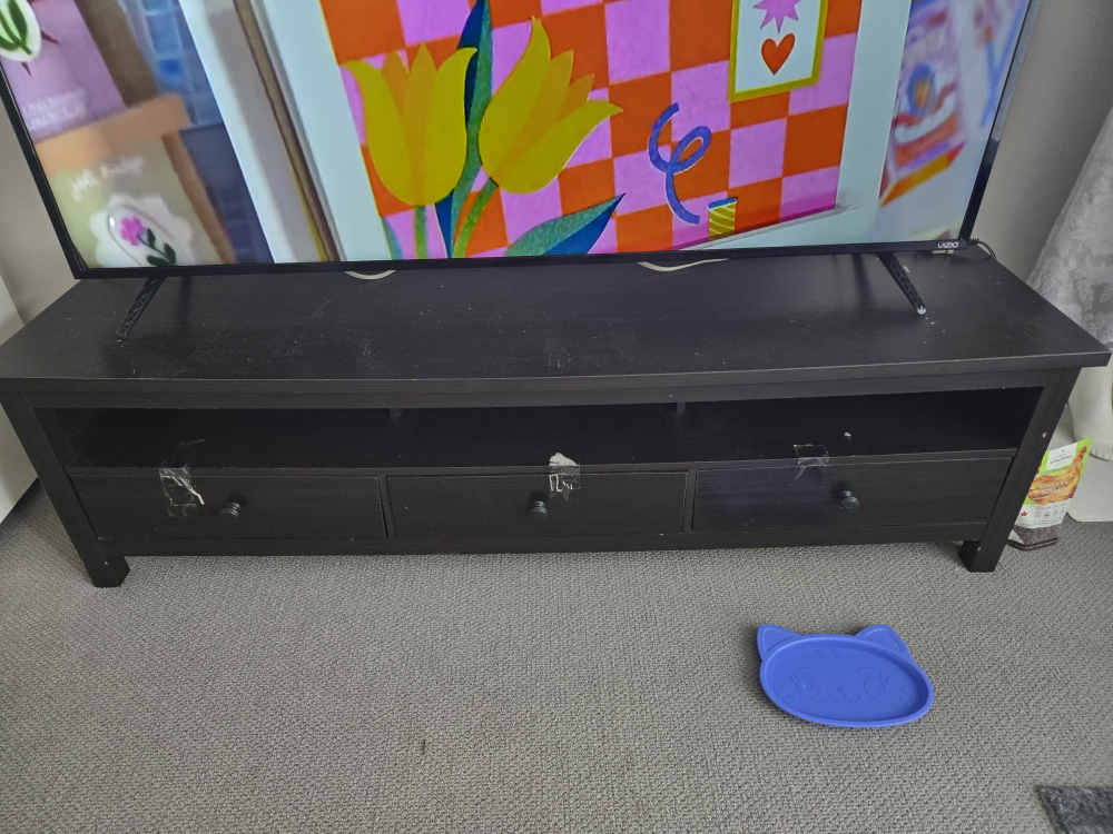 Dark brown TV stand with three drawers