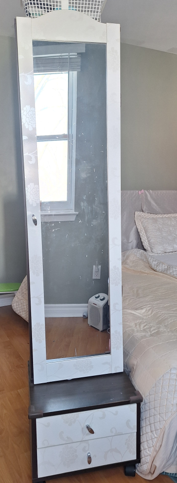 Tall mirrored armoire with storage