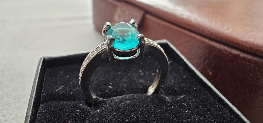 Ring with Teal Oval Gemstone and zirconia accents