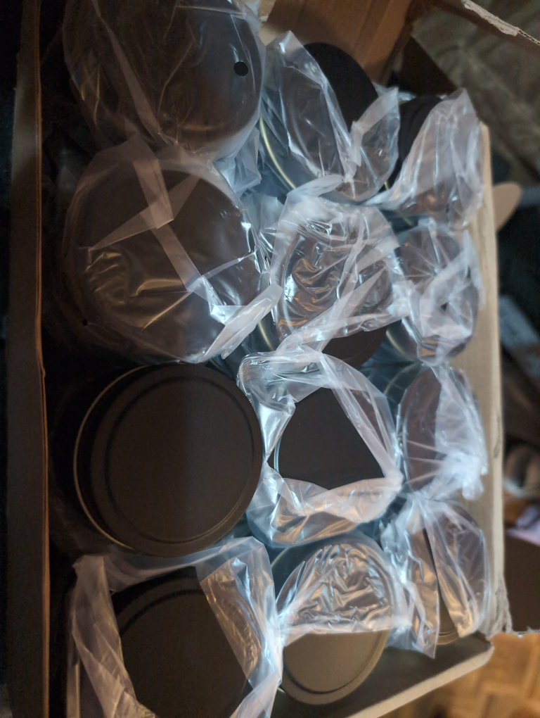 Bulk lot of black metal tins