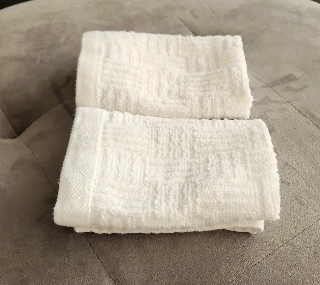 Trio of White Textured Washcloths image indicator(8)