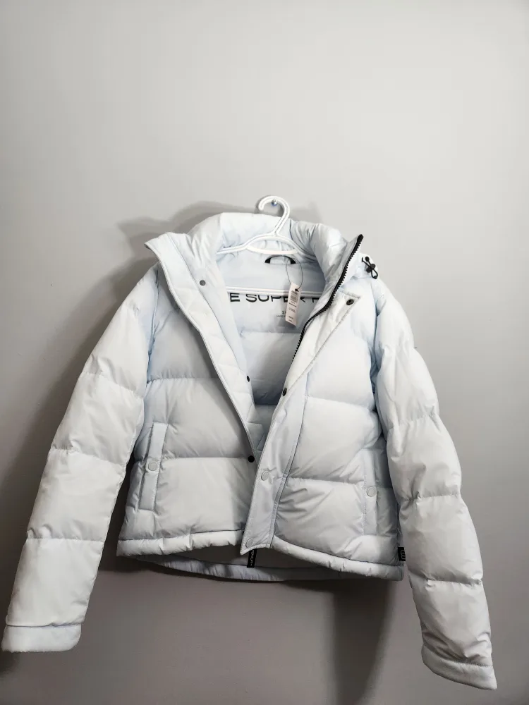 The Super Puff Light Blue Cropped Puffer Jacket with a tag image indicator(2)