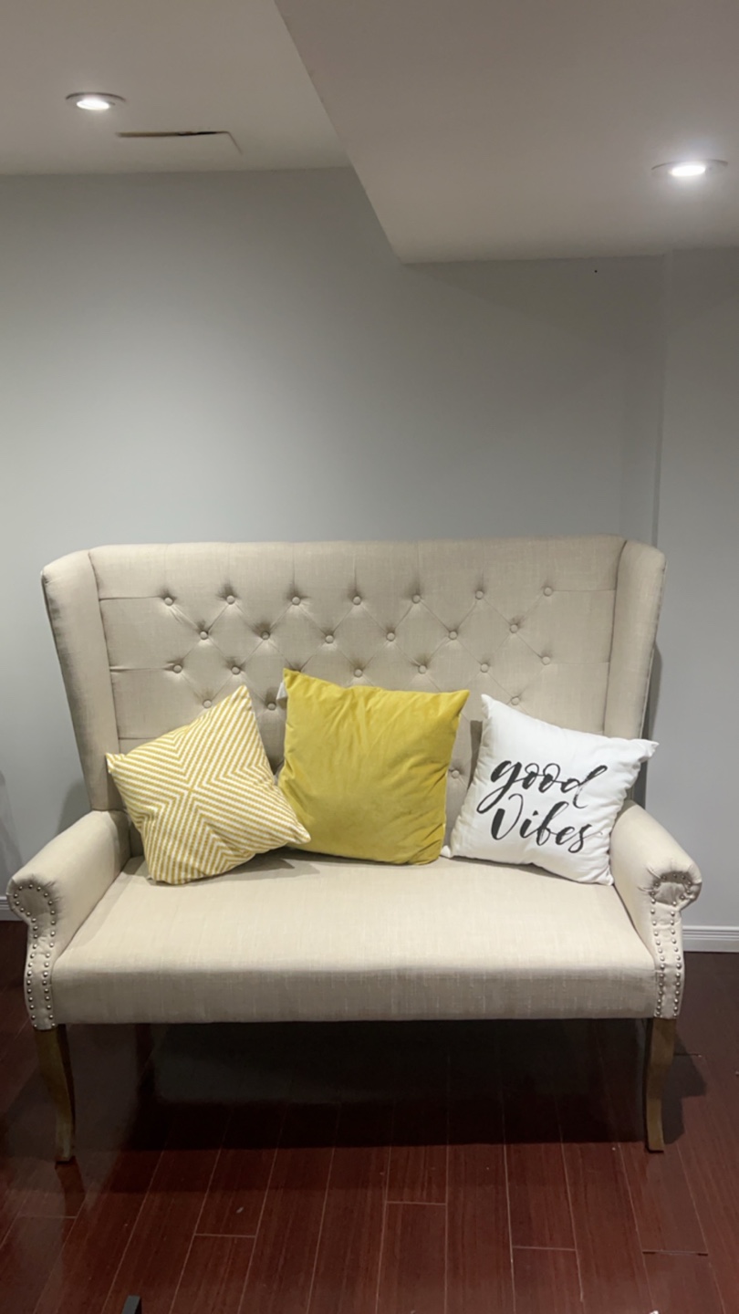 Beige Wingback Sofa with Throw Pillows