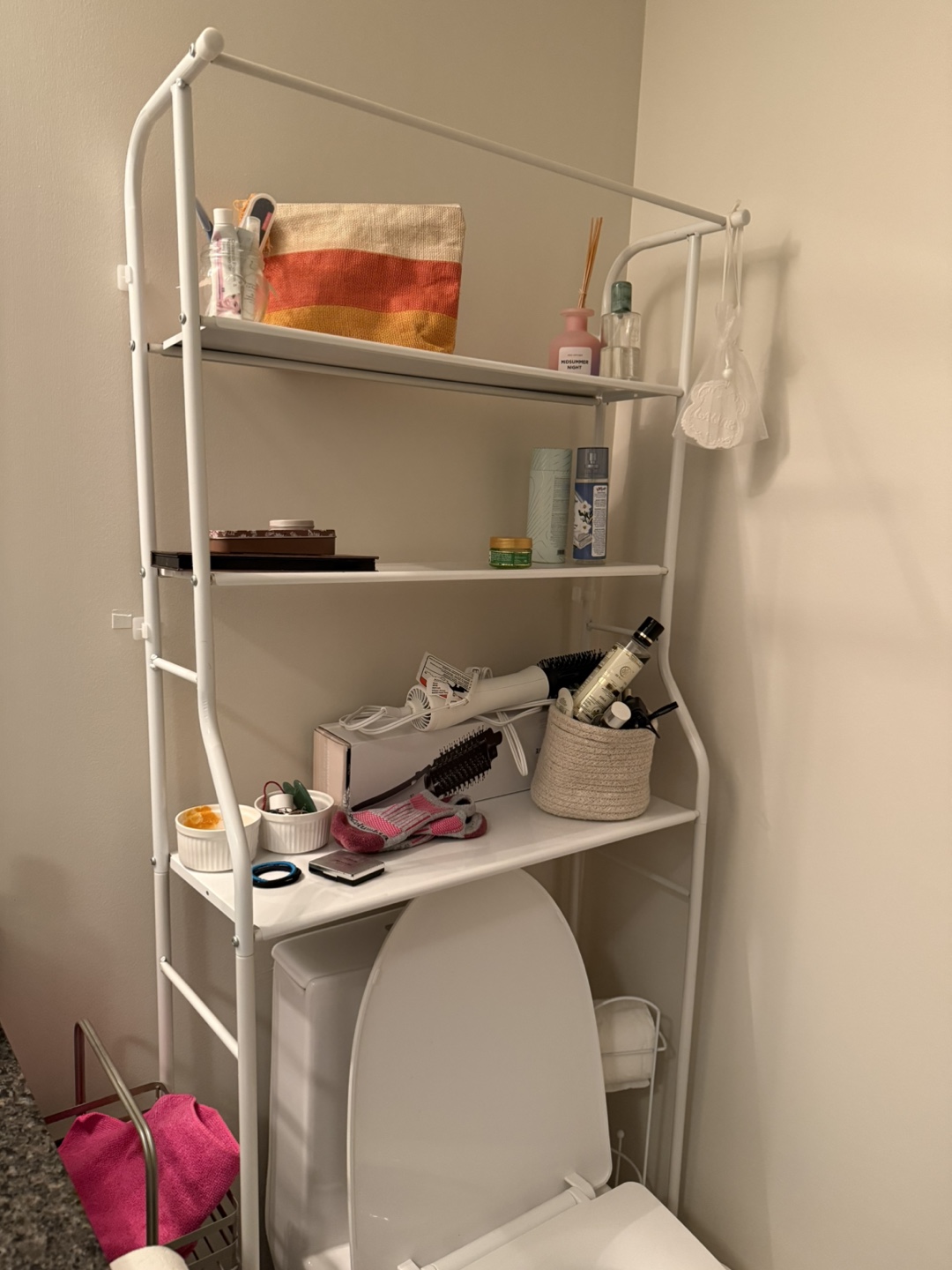White over-toilet storage shelf