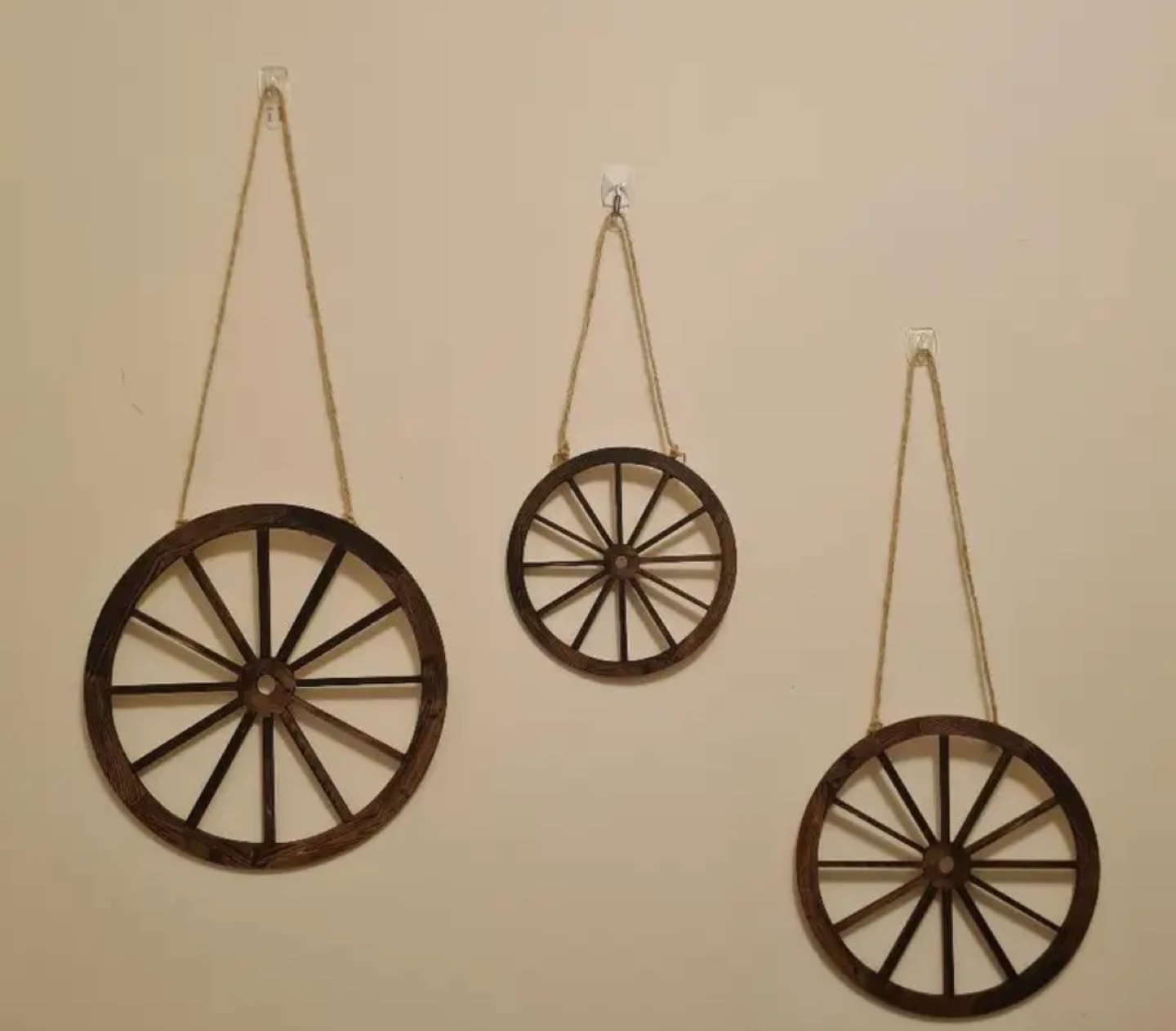 Set of three wooden wagon wheel wall hangings