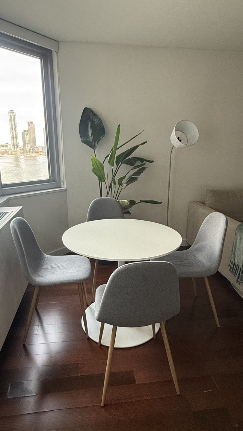 Round White Dining Table with Four Grey Fabric Chairs
