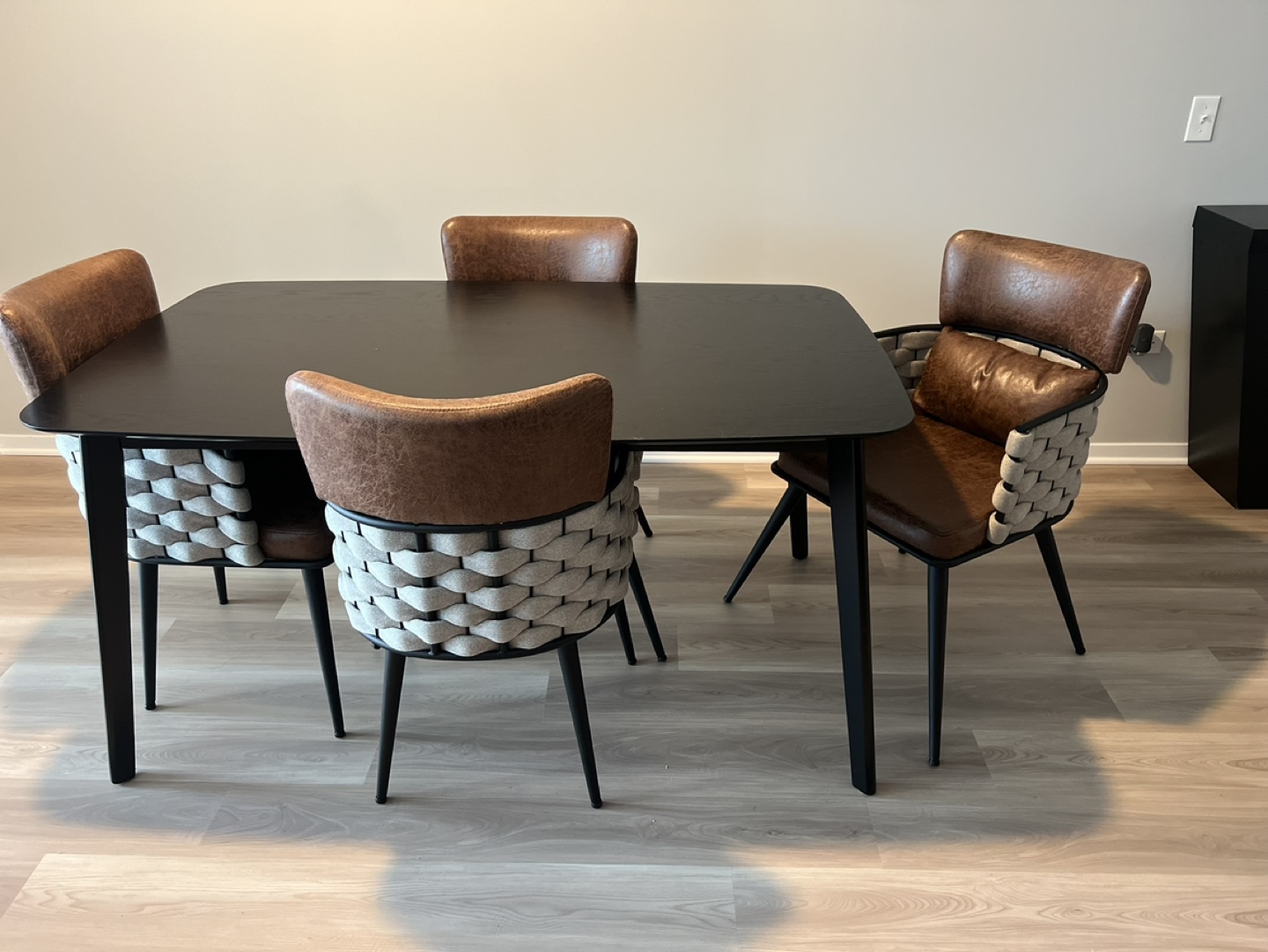 Modern Black Dining Table with Four Brown Leather Chairs