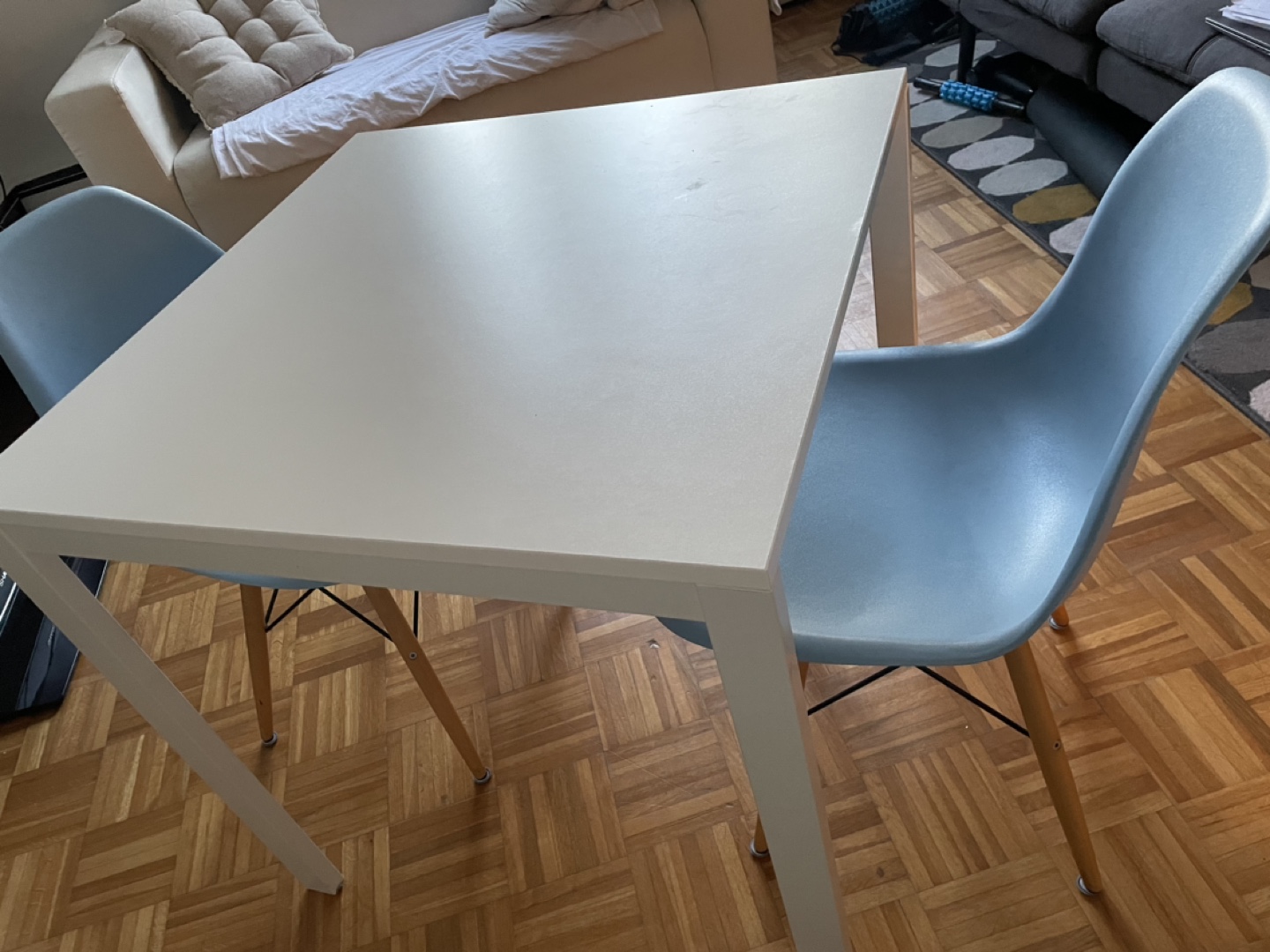 Small White Table and Two Light Blue Chairs