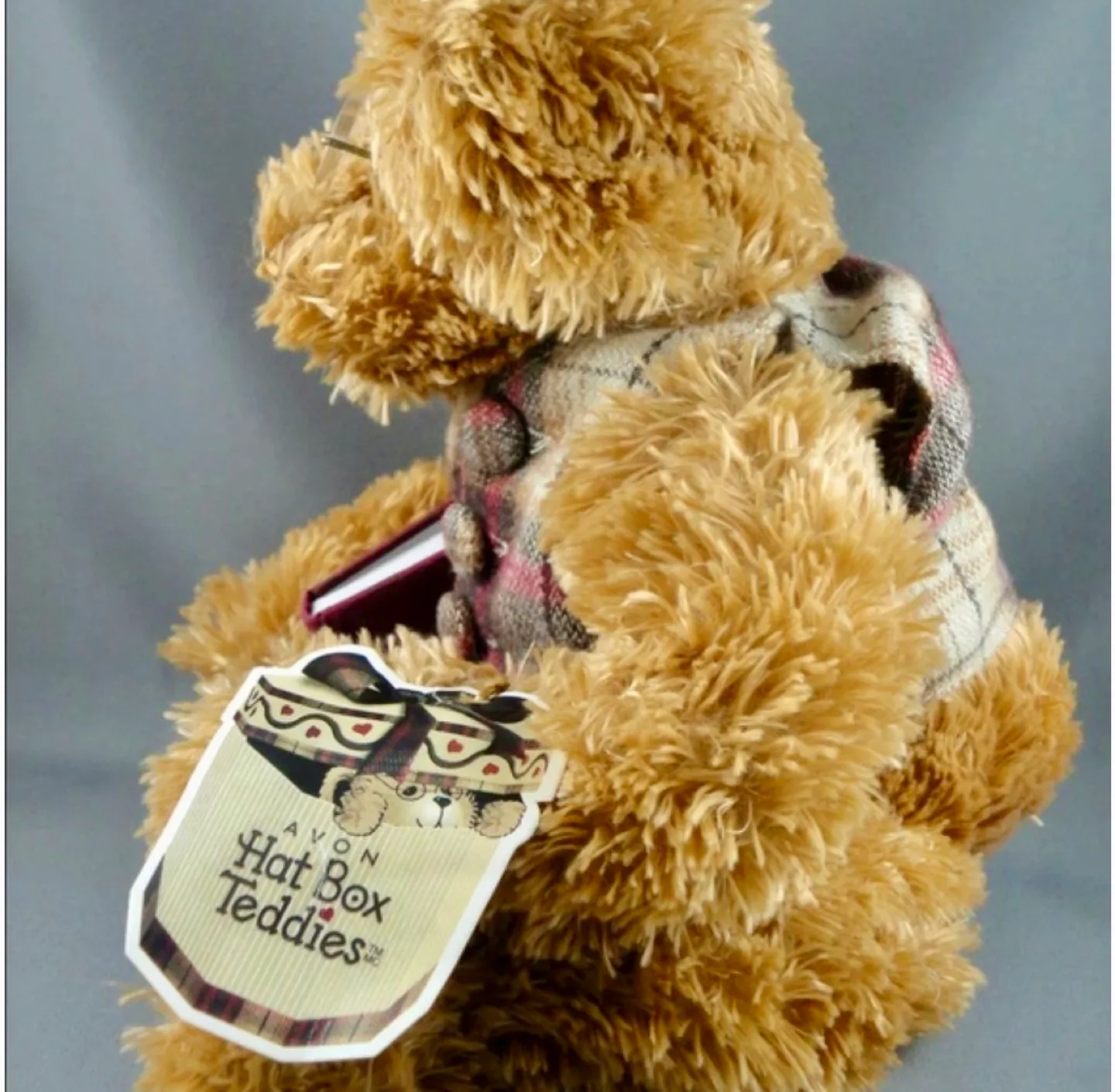 A Harrods Teddy Bear sitting in a small, overstuffed chair image indicator(4)