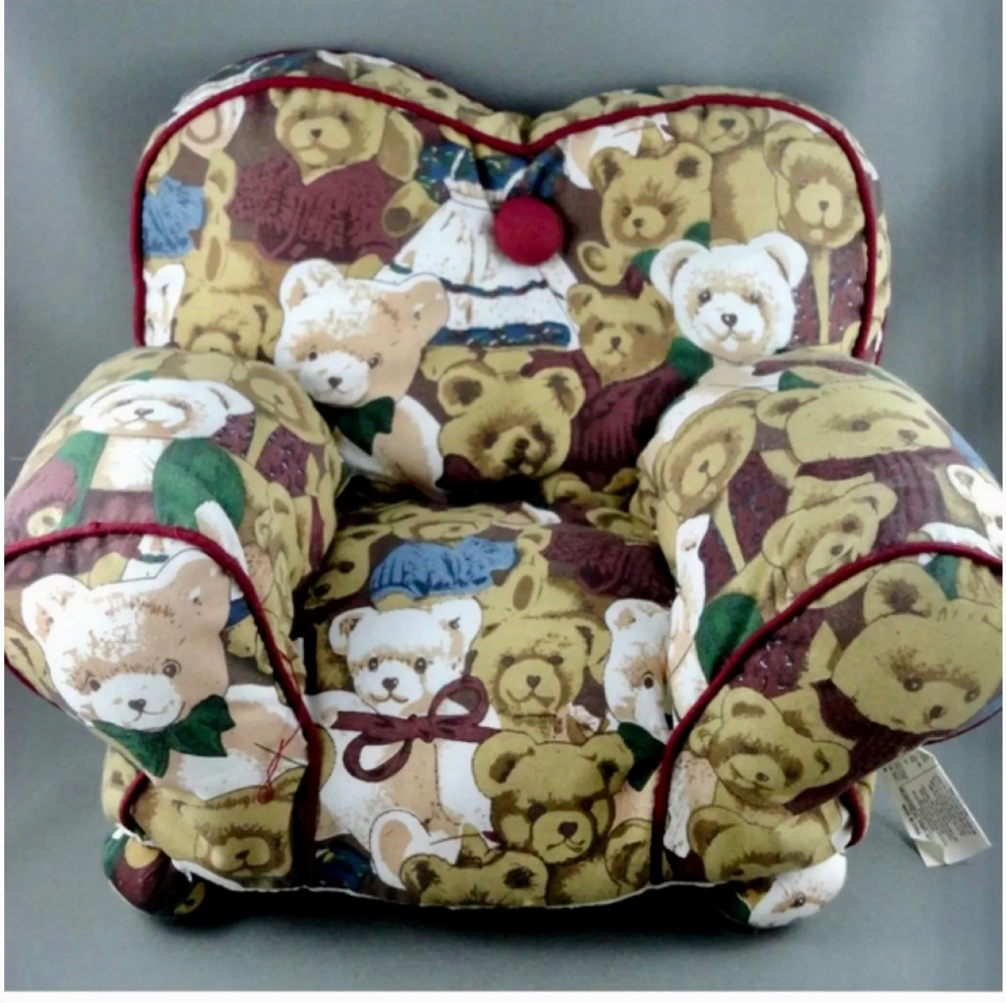 A Harrods Teddy Bear sitting in a small, overstuffed chair image indicator(3)