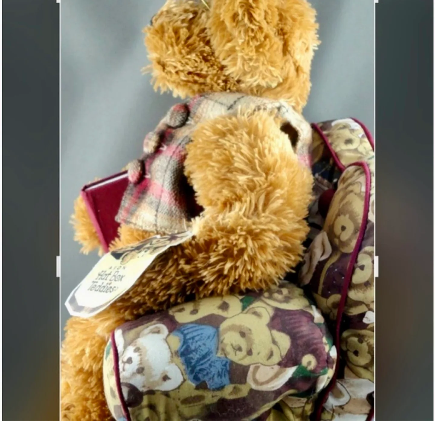A Harrods Teddy Bear sitting in a small, overstuffed chair image indicator(5)