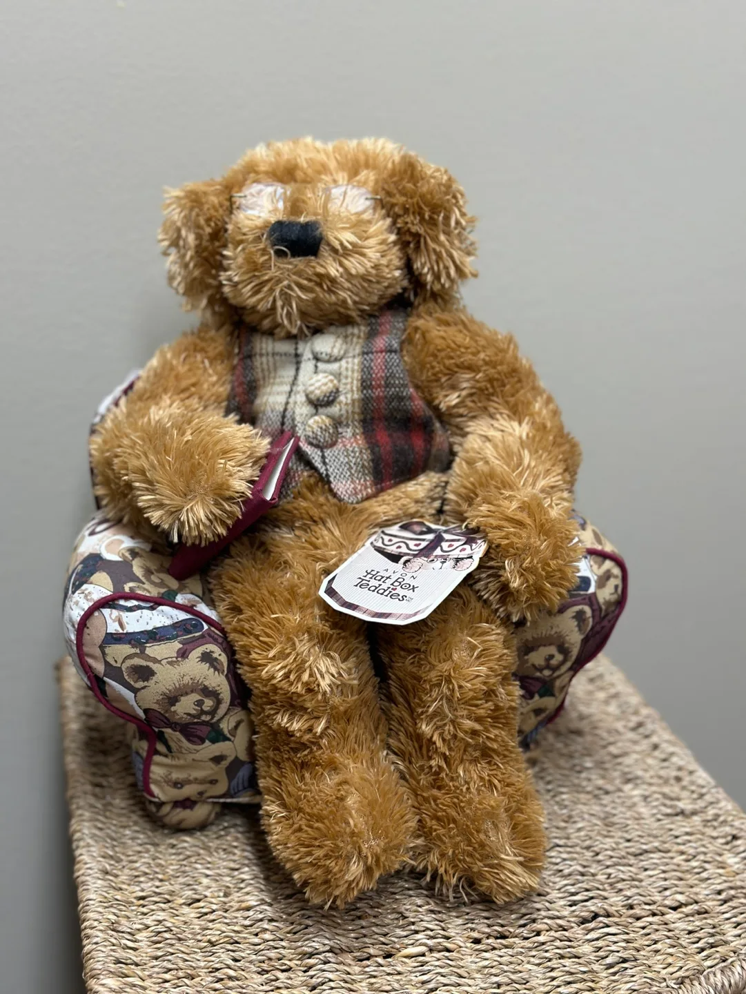 A Harrods Teddy Bear sitting in a small, overstuffed chair image indicator(6)