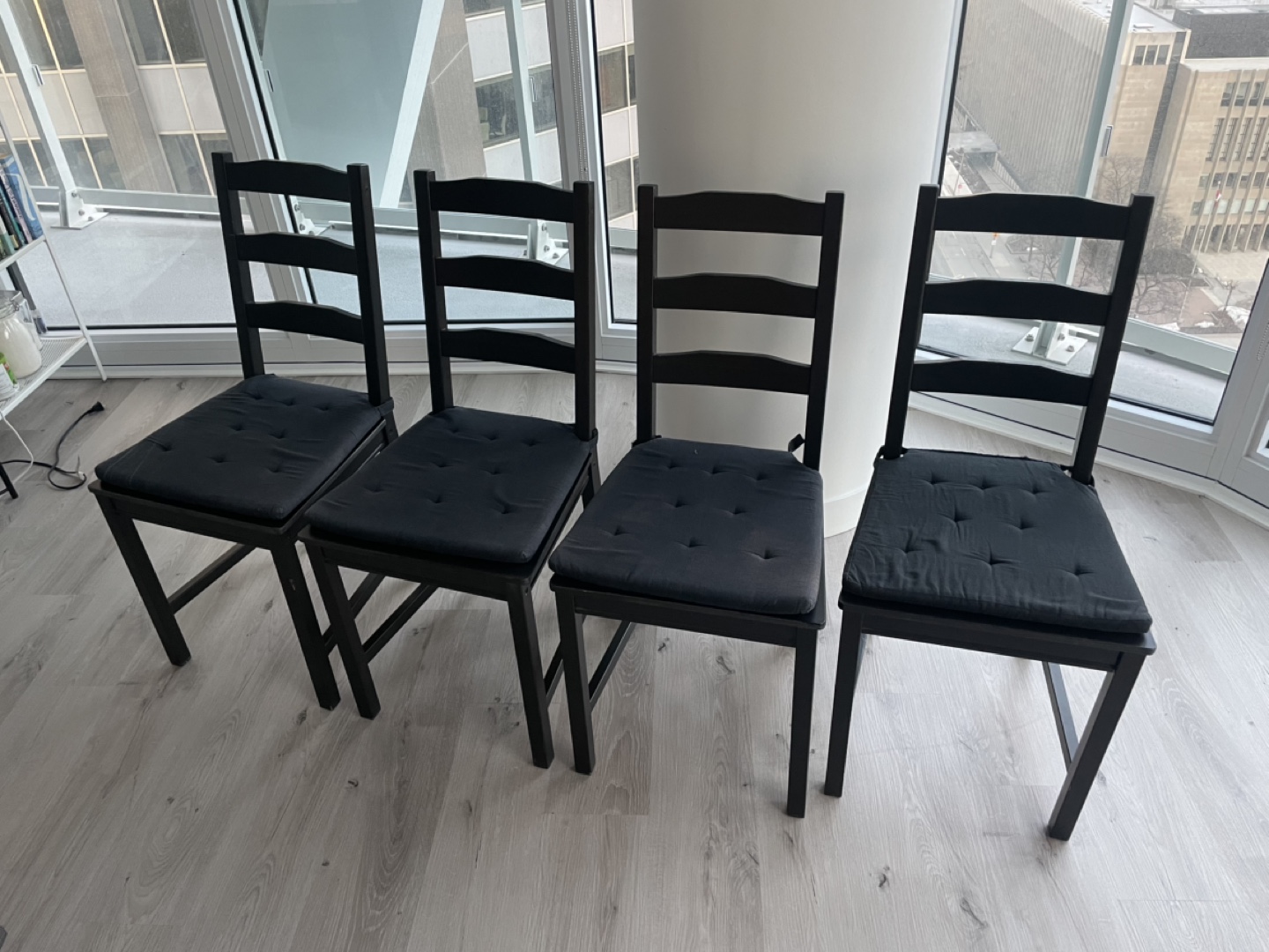 Four Black Dining Chairs with Cushions