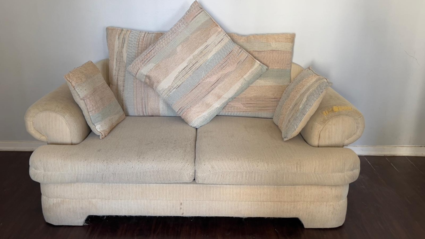 Beige Two-Seater Sofa with Pillows