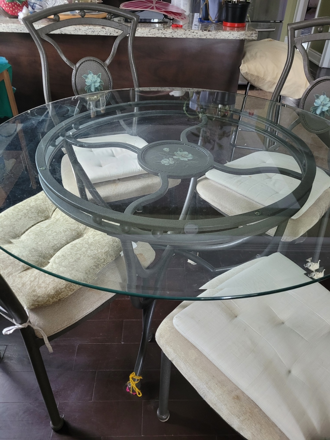 Glass-top dining table set with four chairs