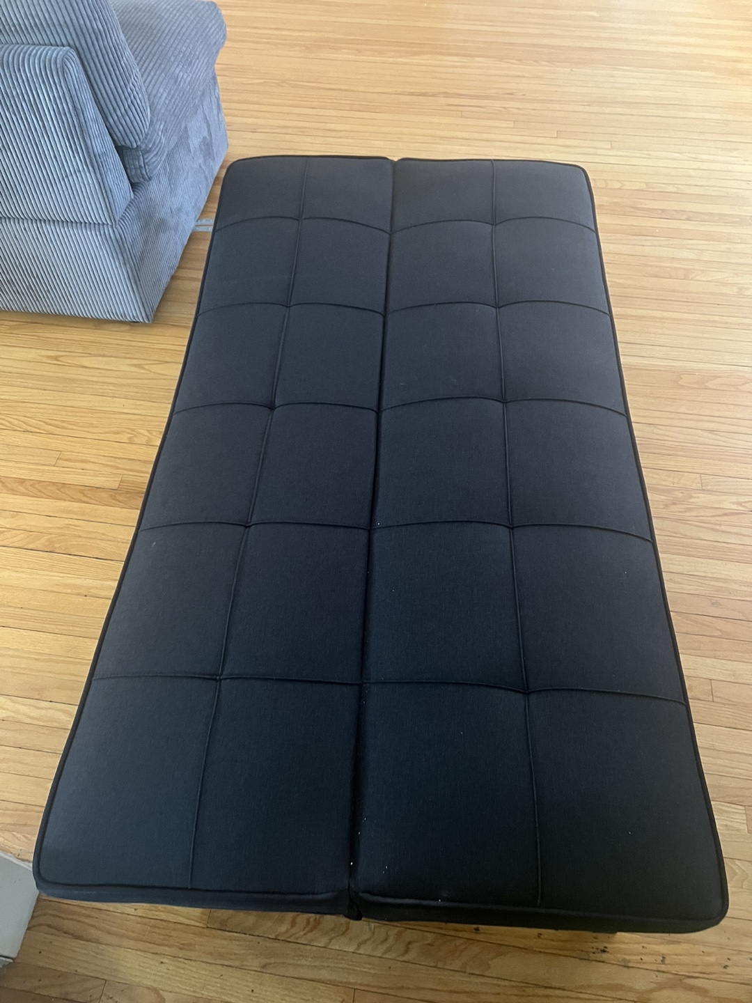 Brown Leather Recliner, Black Storage Ottoman, and Black Futon