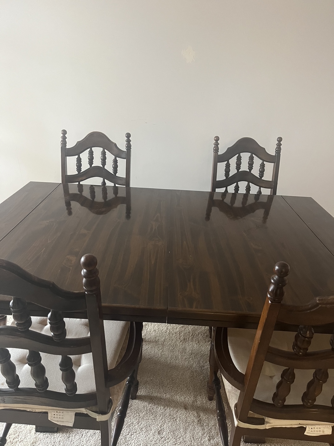 Dark brown dining table with four free chairs