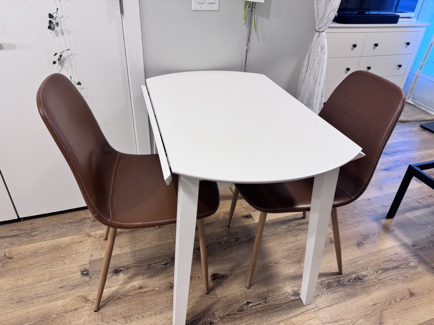 White Round Drop Leaf Table with Two Brown Chairs