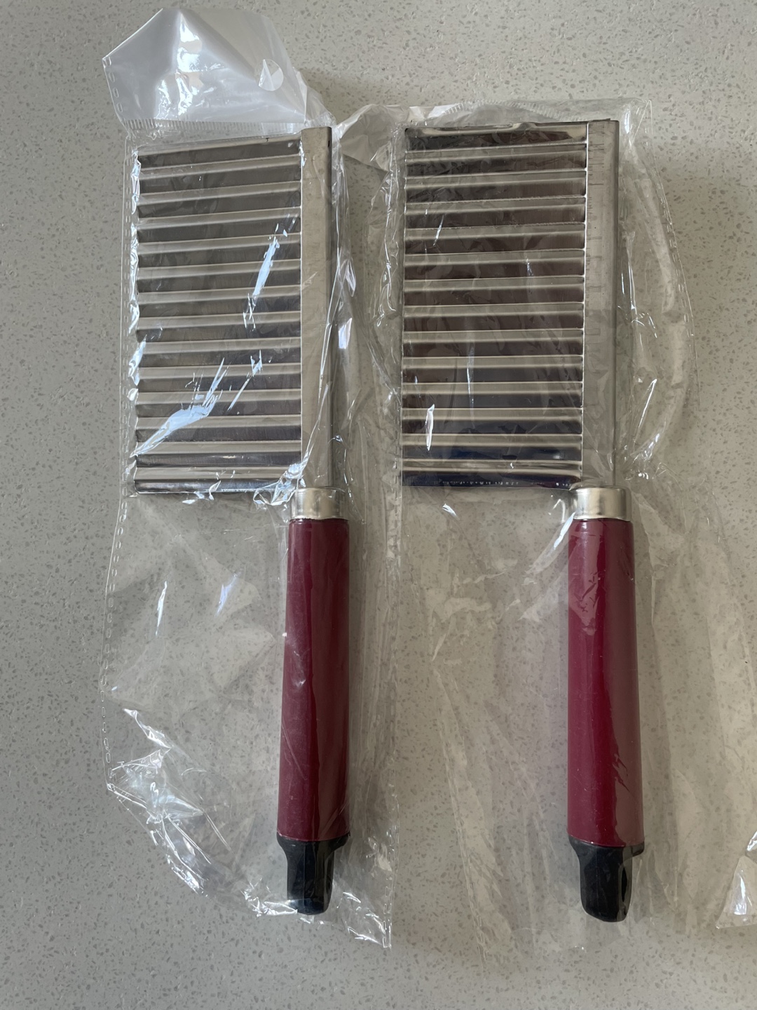 Two Stainless Steel Vegetable Slicers with Burgundy Handles
