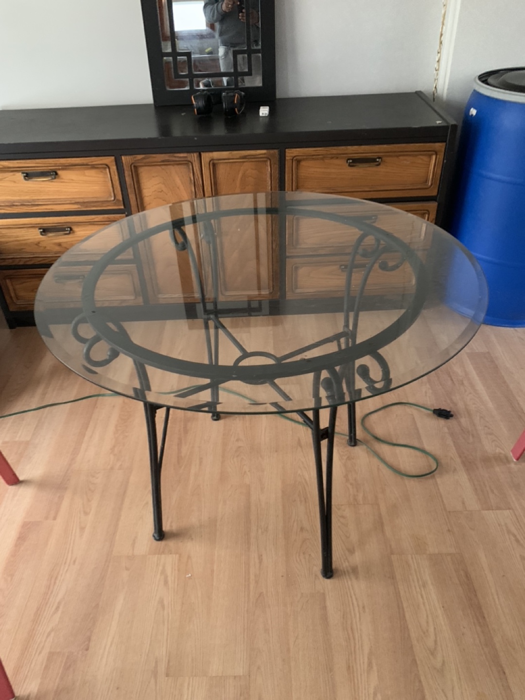 Glass-top dining table with wrought iron base