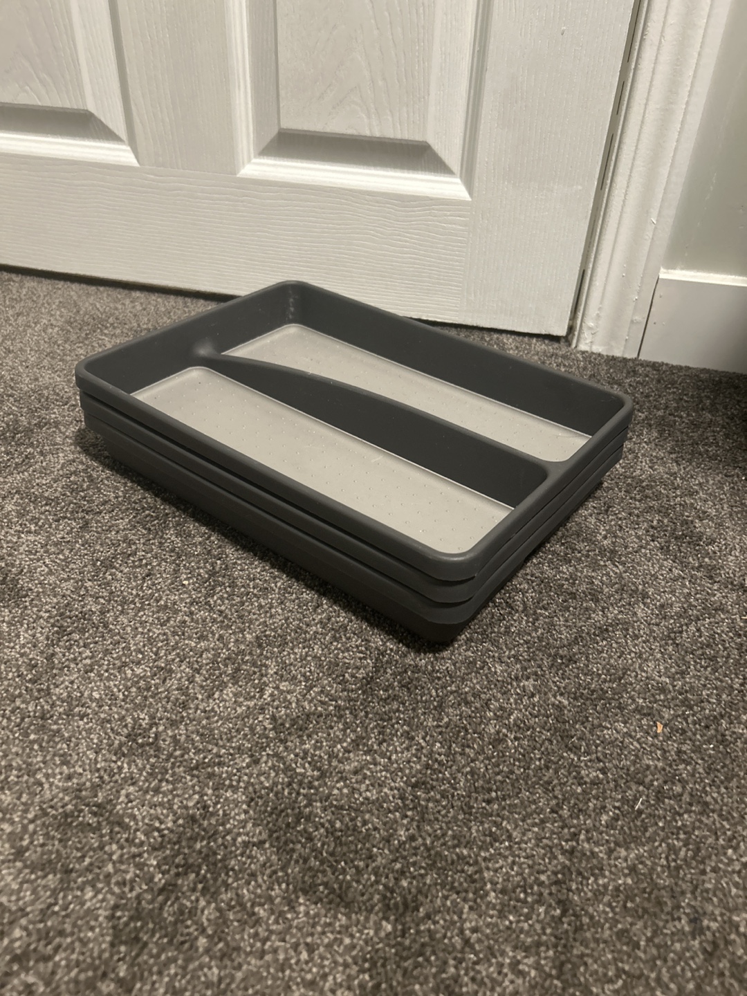 Three grey plastic cutlery trays