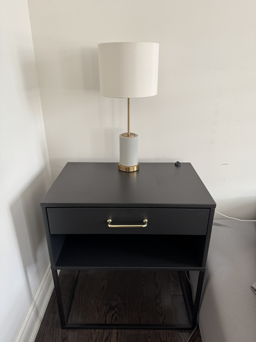 Black nightstand with gold handles and soft close drawer