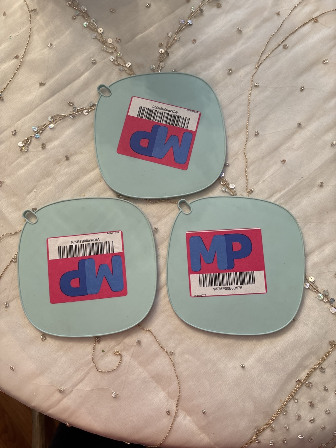 Three teal silicone pot holders