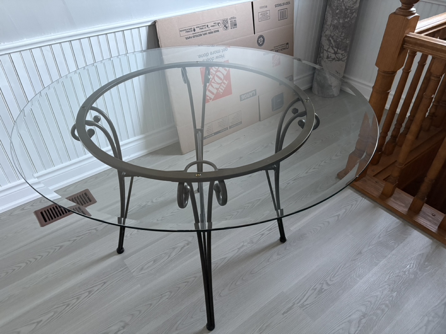 Glass-top dining table with metal base