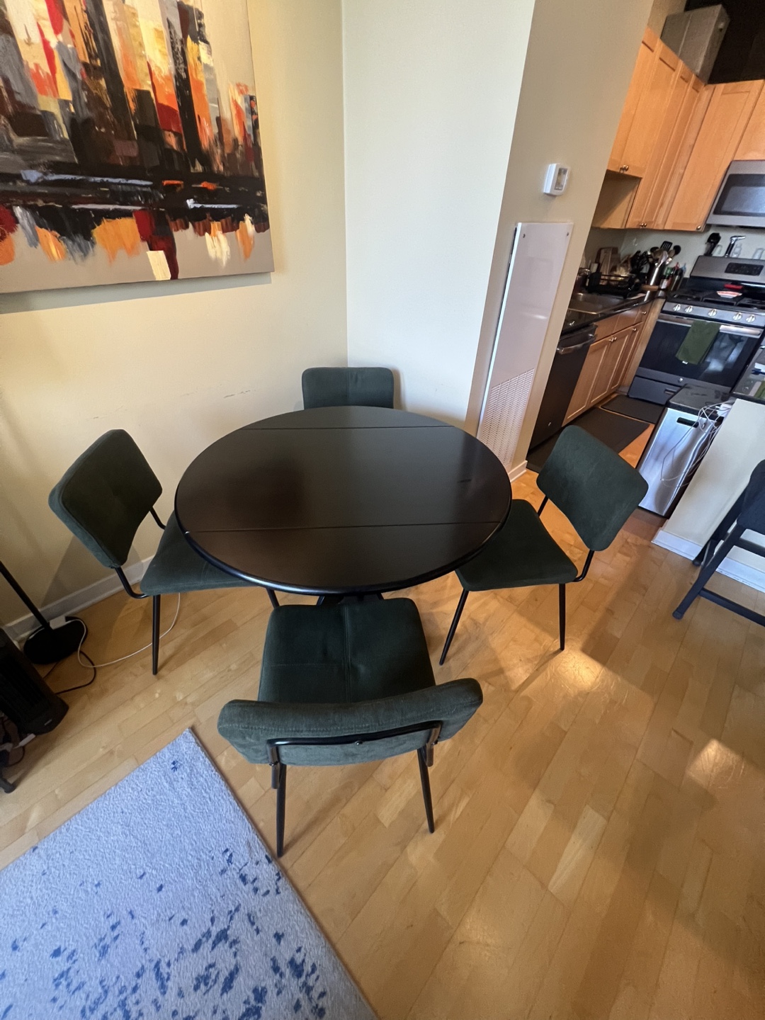 Black Drop Leaf Table with Four Green Chairs