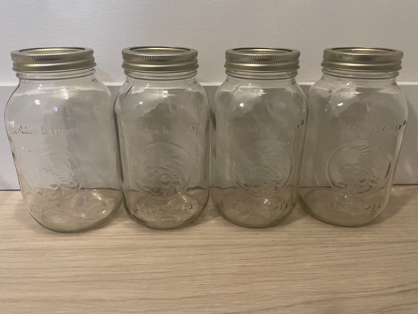 Four Golden Harvest Mason Jars
