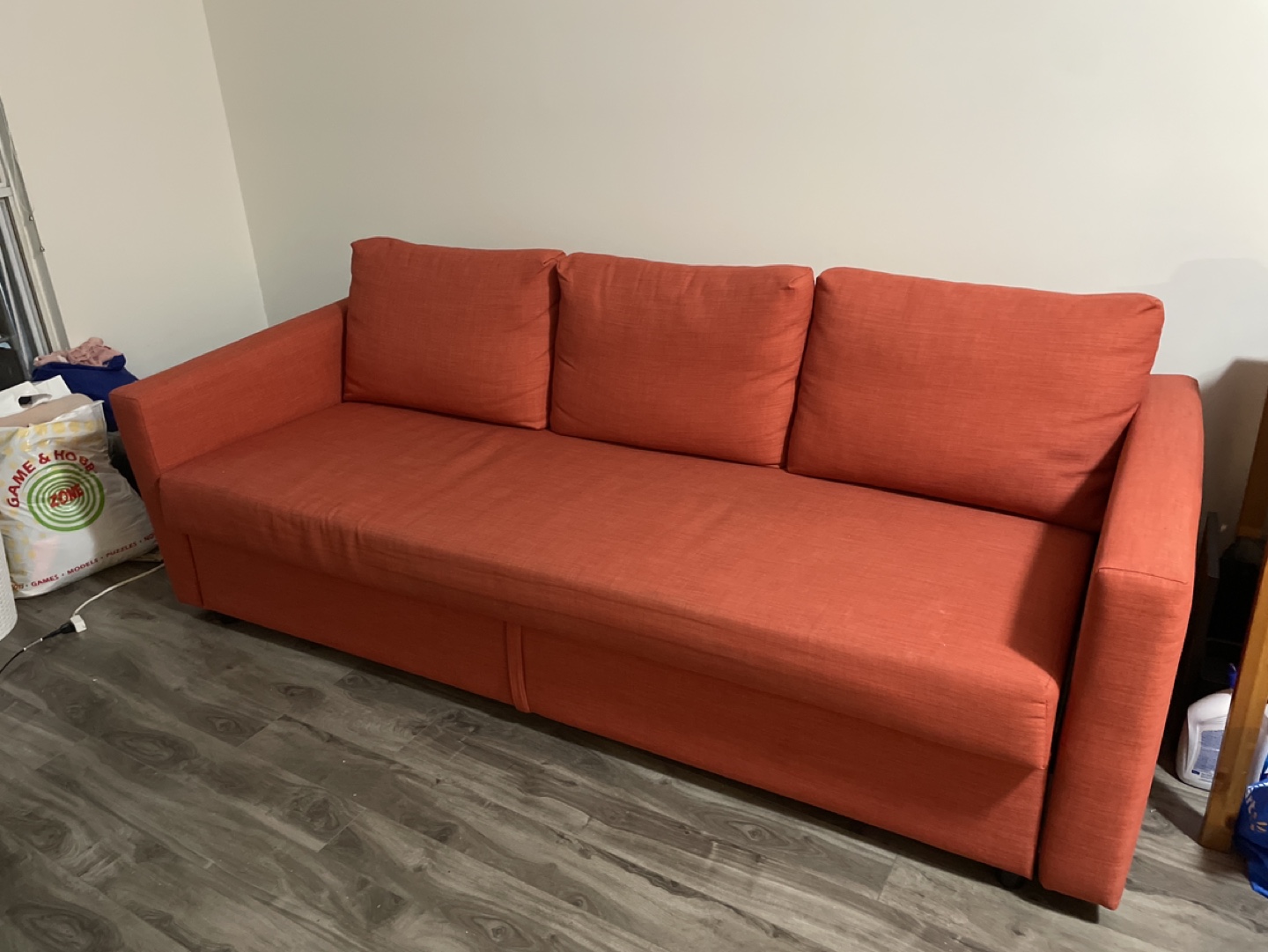 MOVE-OUT SALE - IKEA FRIHETEN Sofa-Bed, Red-Orange - photo 2