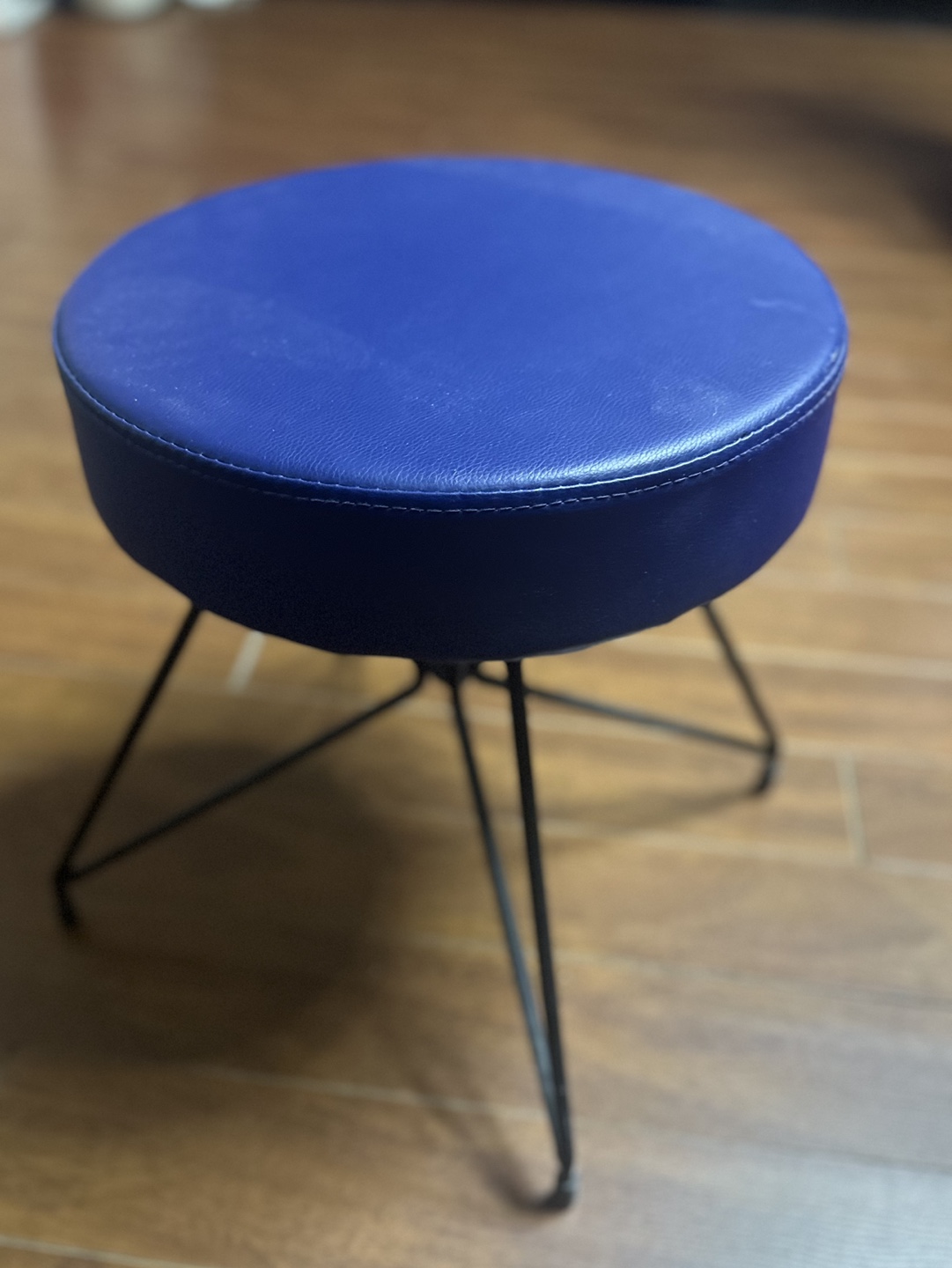 Round navy blue upholstered stool