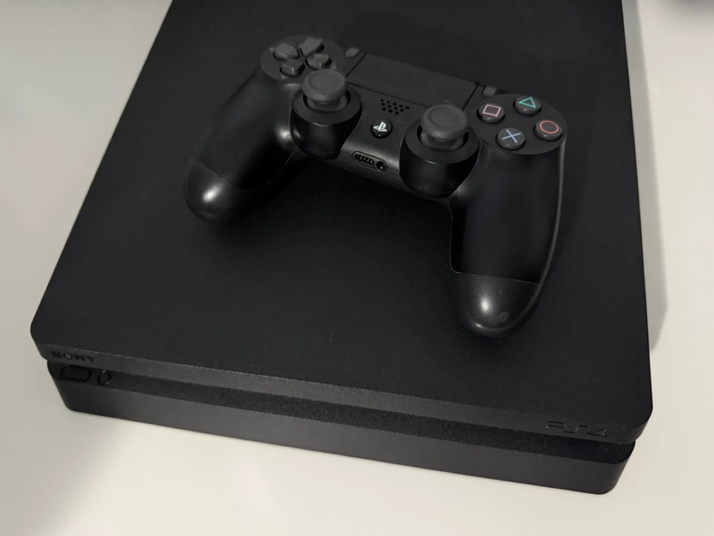 PS4 Slim Console with Black Controller image indicator(2)
