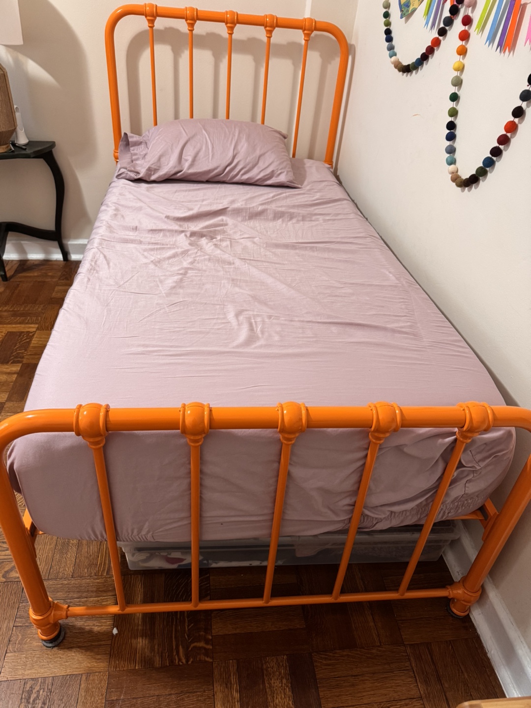 Twin sized metal Orange colored bed frame.