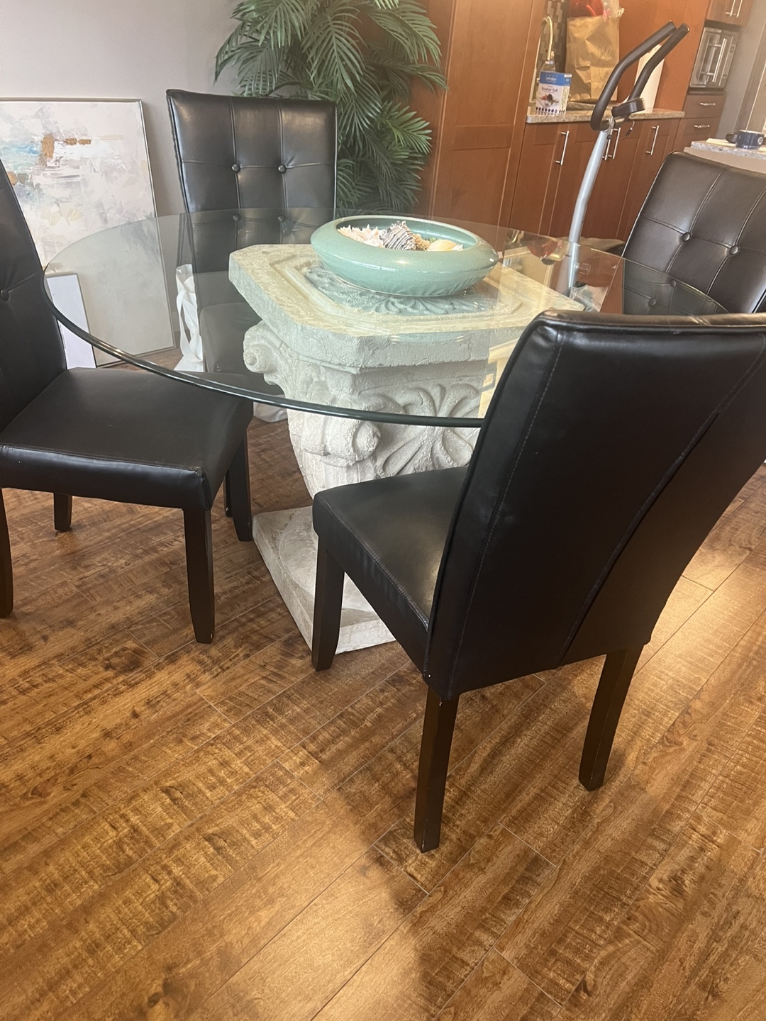 Glass-top dining table with four chairs