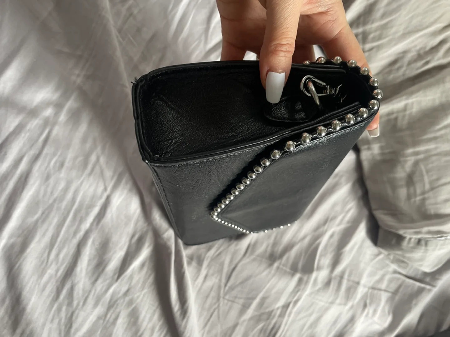 Black studded crossbody bag. Free with any purchase image indicator(2)