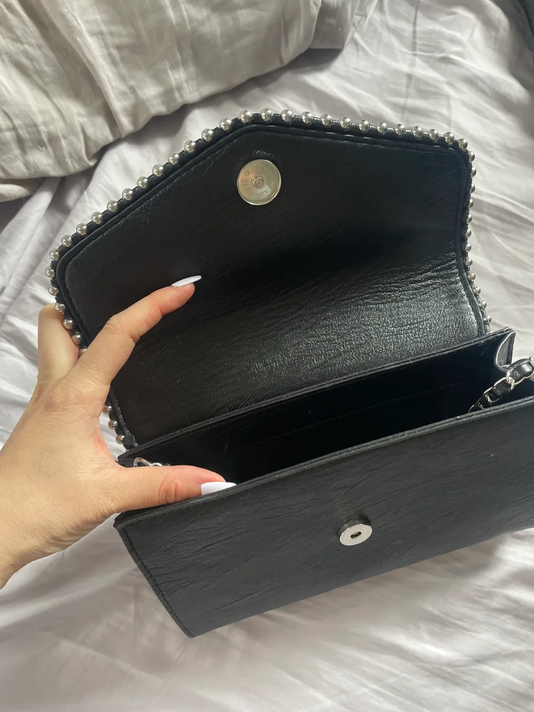 Black studded crossbody bag. Free with any purchase image indicator(3)