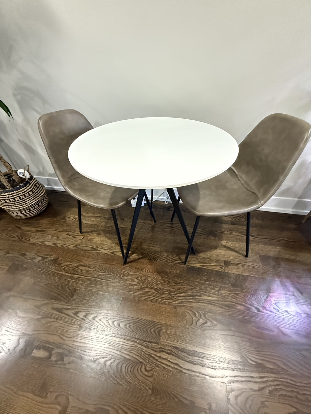 Round White Table with Two Brown Chairs