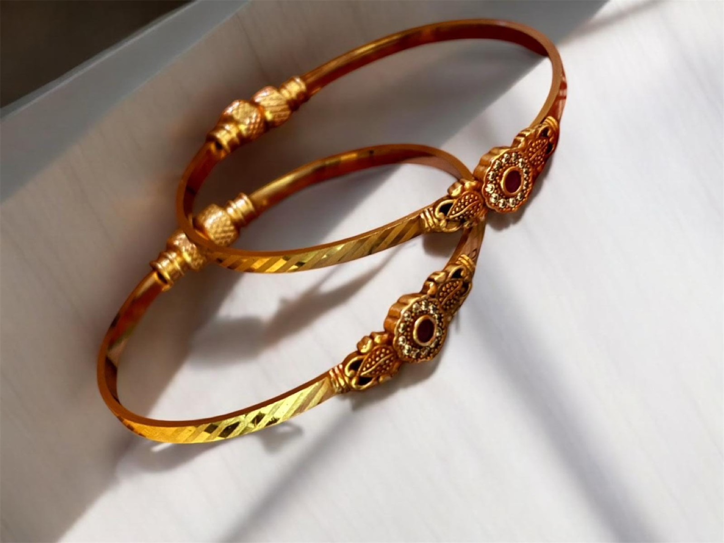 Pair of Gold plated Bangles with Red Stone Accents