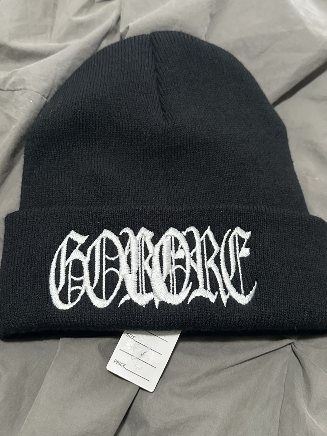 Black knit beanie with embroidered design