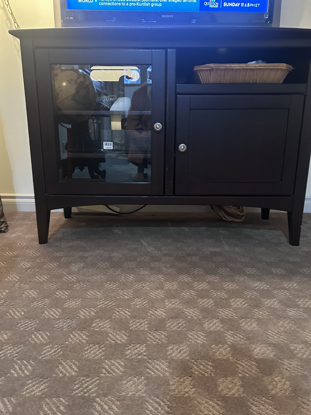 Dark brown wooden TV stand with glass door
