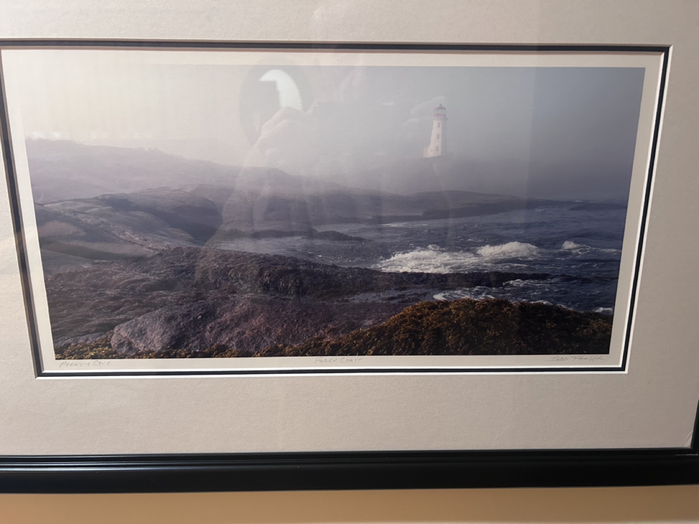 Framed coastal lighthouse photograph
