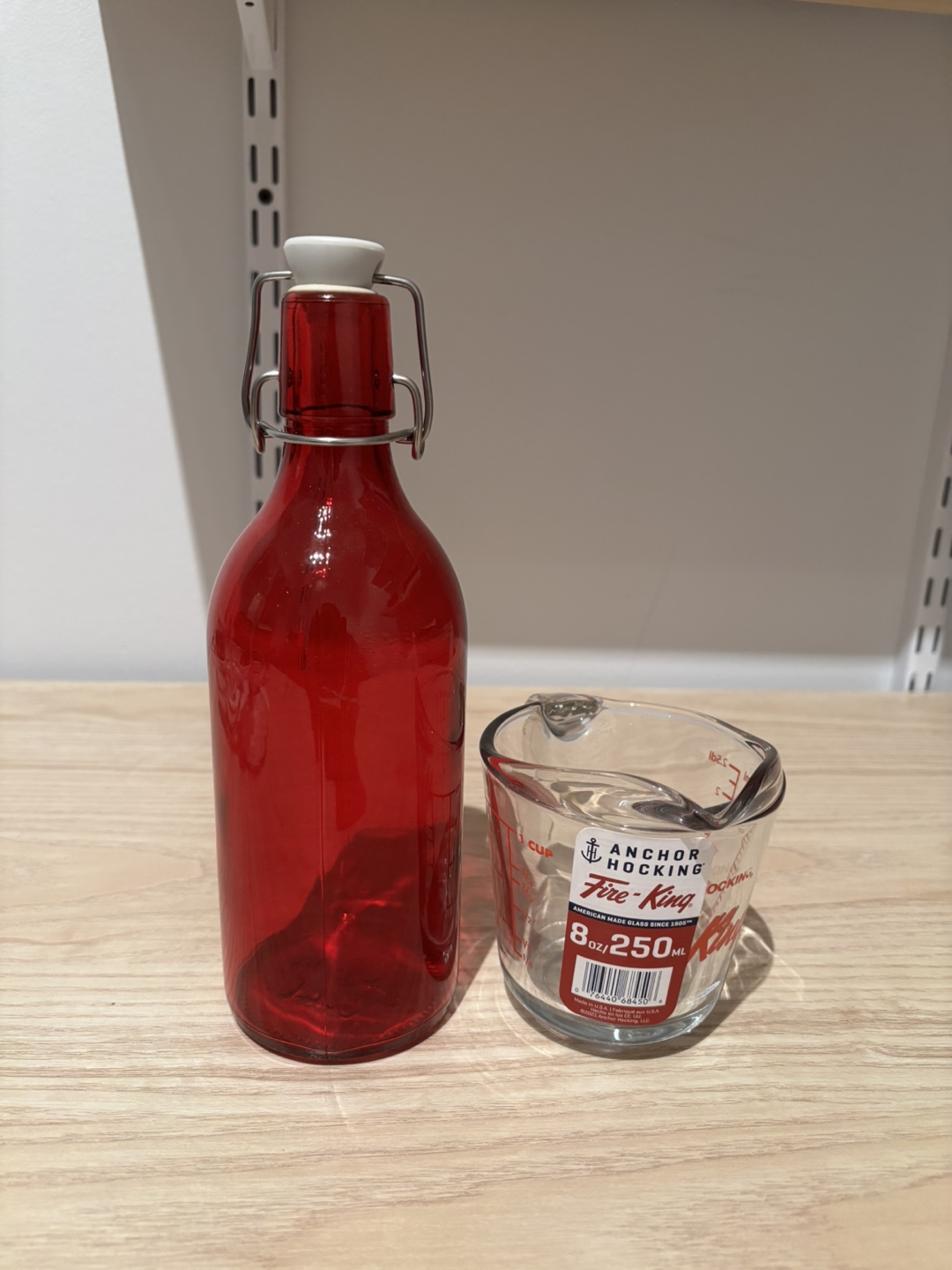 Red Glass Bottle and Measuring Cup