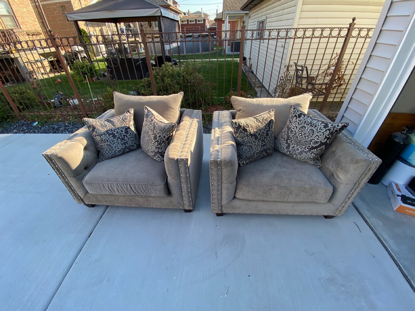 Pair of Brown Upholstered Accent Chairs with Pillows